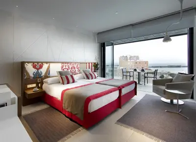 a bedroom with a large bed and a large window at Parador de Cádiz in Cádiz