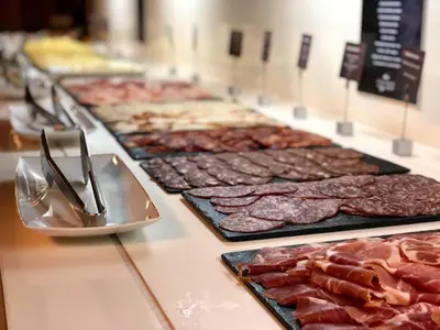 a counter with a bunch of different types of meat at Parador de Cádiz in Cádiz