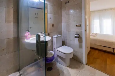 a bathroom with a toilet and a sink and a shower at SH Brisa de la Viña. Cerca de la Playa. AC, WIFi in Cádiz
