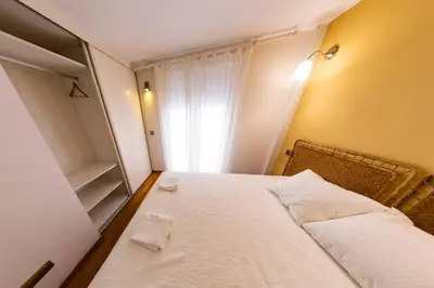 a small bedroom with a bed and a window at SH Brisa de la Viña. Cerca de la Playa. AC, WIFi in Cádiz