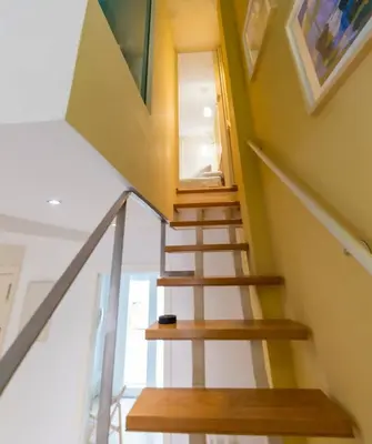 a staircase in a house with yellow walls at SH Brisa de la Viña. Cerca de la Playa. AC, WIFi in Cádiz