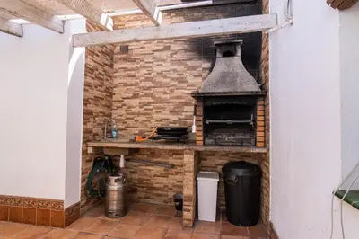 an outdoor kitchen with a brick wall and an oven at Parisito beach in Chiclana de la Frontera