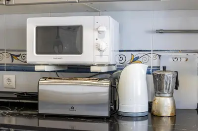 a microwave oven sitting on top of a kitchen counter at Parisito beach in Chiclana de la Frontera
