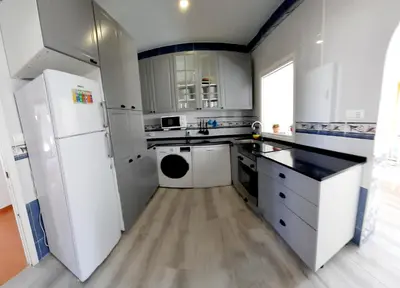 a kitchen with white appliances and a white refrigerator at Parisito beach in Chiclana de la Frontera