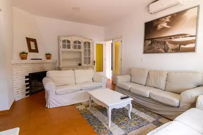 a living room with two white couches and a fireplace at Parisito beach in Chiclana de la Frontera