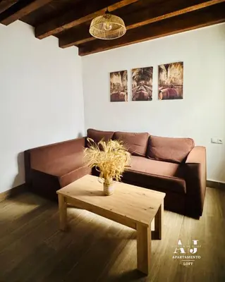 a living room with a couch and a coffee table at Apartamento con Entreplanta Alegría de Jerez in Jerez de la Frontera