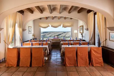 a room with tables and chairs in a building at Parador de Arcos de la Frontera in Arcos de la Frontera