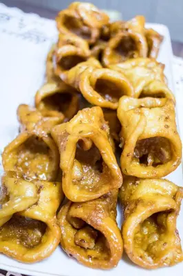 a pile of glazed donuts on a white plate at Parador de Arcos de la Frontera in Arcos de la Frontera
