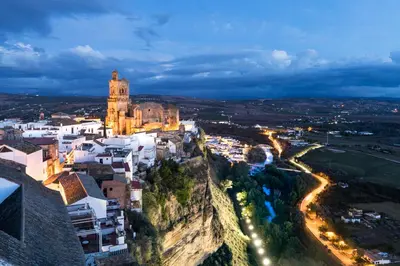 a city on a mountain at night at Parador de Arcos de la Frontera in Arcos de la Frontera