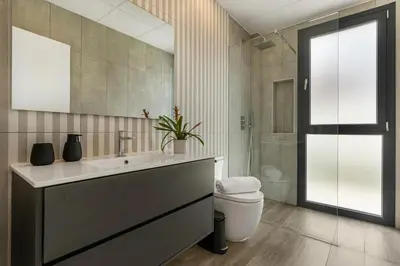 a bathroom with a sink and a toilet and a mirror at Villa Paradisus Golf & Wellnes in Cádiz