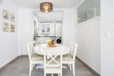 a white dining room with a white table and chairs at Conil Seaside Hideaway in Conil de la Frontera
