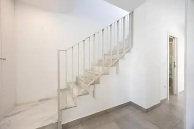 a staircase in a white room with white walls at Conil Seaside Hideaway in Conil de la Frontera