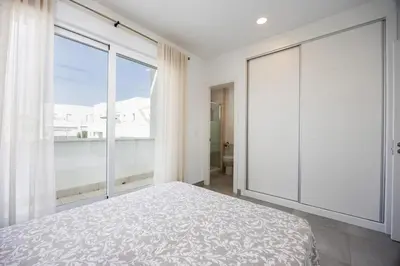 a bedroom with a bed and a large window at Conil Seaside Hideaway in Conil de la Frontera