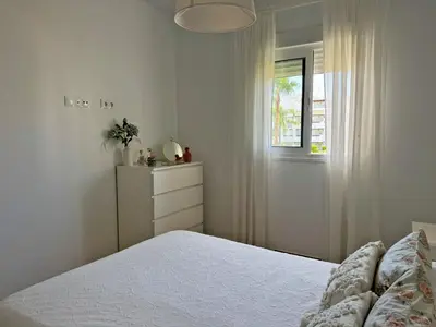 a white bedroom with a bed and a window at Apartamento Brisa Candor - Ole Solutions in Rota