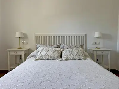 a bedroom with a white bed with two night stands at Apartamento Brisa Candor - Ole Solutions in Rota