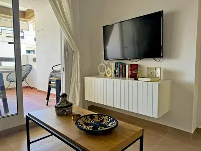 a living room with a flat screen tv on a wall at Apartamento Brisa Candor - Ole Solutions in Rota