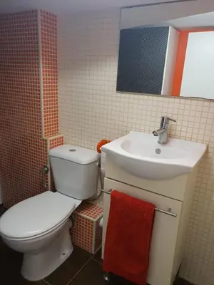 a bathroom with a white toilet and a sink at Mina5 in Cádiz