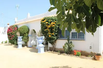 a house with flowers on the side of it at Alojamiento Rural 