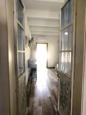 an empty hallway with an open door and a piano at Alojamiento Rural 