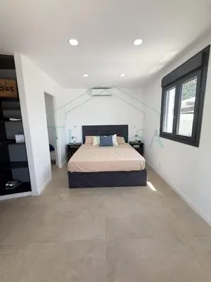 a bedroom with a bed in the middle of a room at Villa Foreber in Chiclana de la Frontera