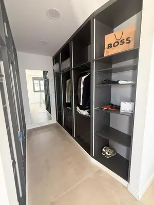 a walk in closet with black shelves at Villa Foreber in Chiclana de la Frontera