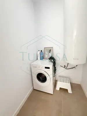 a washer and dryer in a white laundry room at Villa Foreber in Chiclana de la Frontera