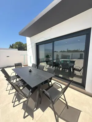a black table and chairs on a patio at Villa Foreber in Chiclana de la Frontera