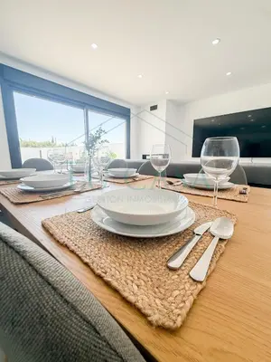 a table with plates and wine glasses on it at Villa Foreber in Chiclana de la Frontera