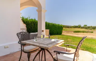 a patio with a table with wine glasses on it at Pet Friendly Home In Arcos De La Frontera in Arcos de la Frontera