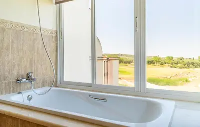 a white bath tub in a bathroom with a window at Pet Friendly Home In Arcos De La Frontera in Arcos de la Frontera