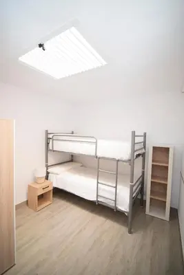 a room with two bunk beds and a skylight at Stylish 3-Bedrooms Getaway with Terrace & Pool in Chiclana de la Frontera