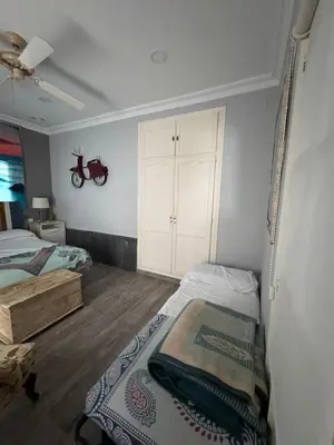 a bedroom with a bed and a white cabinet at Valdelagrana del Mar in El Puerto de Santa María