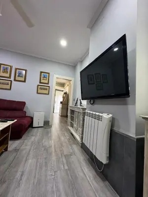 a living room with a flat screen tv on a wall at Valdelagrana del Mar in El Puerto de Santa María