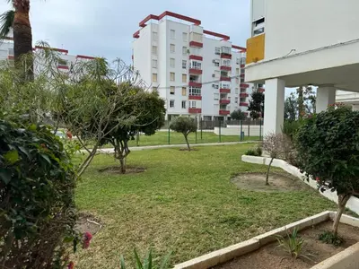 a park in front of a building with trees at Valdelagrana del Mar in El Puerto de Santa María