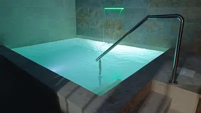 a hot tub with a glass shower backdoor at Villa Juana in Conil de la Frontera