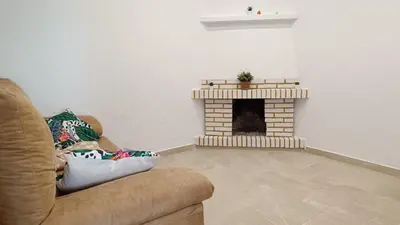 a living room with a couch and a fireplace at Villa Juana in Conil de la Frontera
