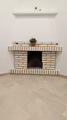 a brick fireplace with a plant on top of it at Villa Juana in Conil de la Frontera