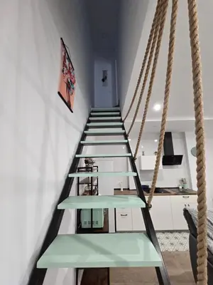 a rope swing in a room with green shelves at Piso El IDEAL in Lebrija