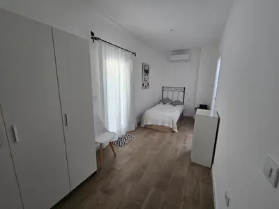 a white room with a bed and a window at Piso El IDEAL in Lebrija