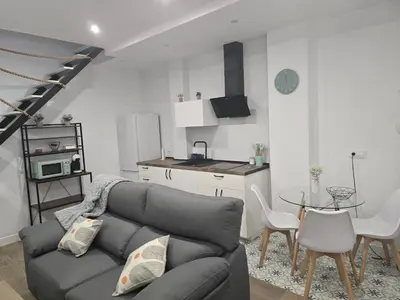 a living room with a couch and a table at Piso El IDEAL in Lebrija