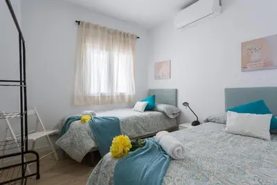 a bedroom with two beds and a window at Allo Apartments Morenos VI in Jerez de la Frontera