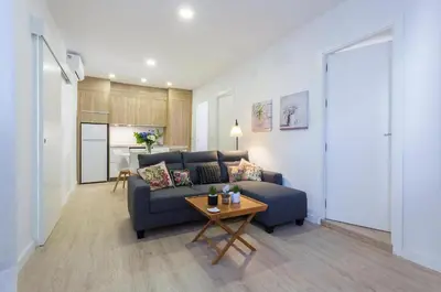 a living room with a blue couch and a table at Allo Apartments Morenos VI in Jerez de la Frontera