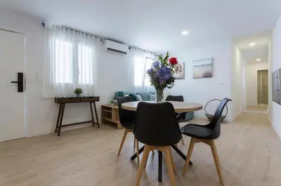 a living room with a table and chairs and a couch at Allo Apartments Morenos VI in Jerez de la Frontera
