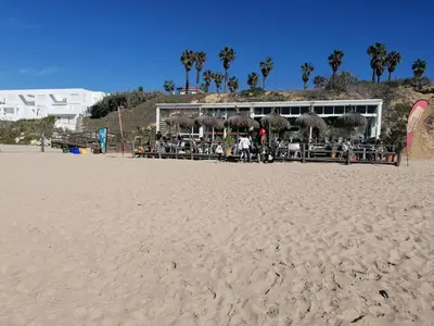 a restaurant on the beach with a sandy beach at Apartamento junto a PLAYA LAS REDES-VISTAHERMOSA, CADIZ in El Puerto de Santa María