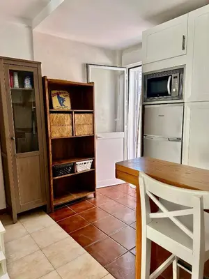 a kitchen with a table and a microwave at Barrosa Living in Chiclana de la Frontera