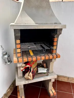 a stone oven with a rack on top of it at Barrosa Living in Chiclana de la Frontera