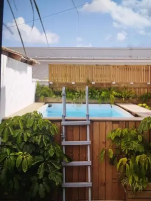 a pool with a ladder next to a wooden fence at Estudio Álvaro in Cádiz