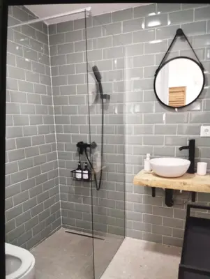 a bathroom with a shower with a sink and a mirror at Estudio Álvaro in Cádiz