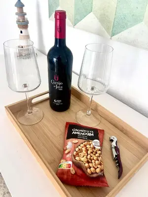 a wooden tray with a bottle of wine and two glasses at Apartamento Relax junto al Mar in El Puerto de Santa María