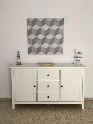 a white dresser in a room with a painting on the wall at Apartamento Relax junto al Mar in El Puerto de Santa María